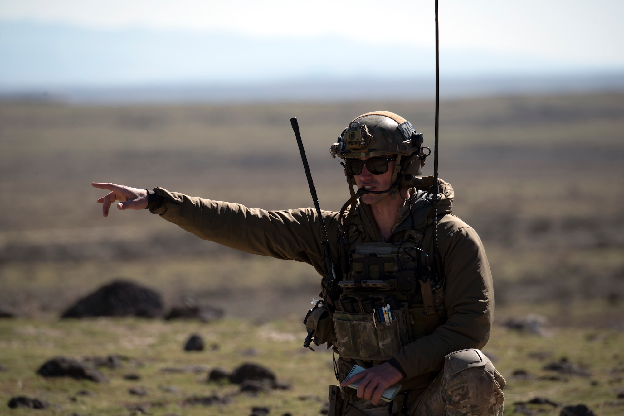 Idaho Air National Guard Joint Terminal Air Controller talks with a pilot of an F-15E Strike Eagle via radio, April 17, 2020, at Orchard Combat Training Center, Idaho. The training gave JTACs and pilots an opportunity to practice live bomb drops while enhancing communication skills between ground and air support. (U.S. Air Force photo by Airman Natalie Rubenak).