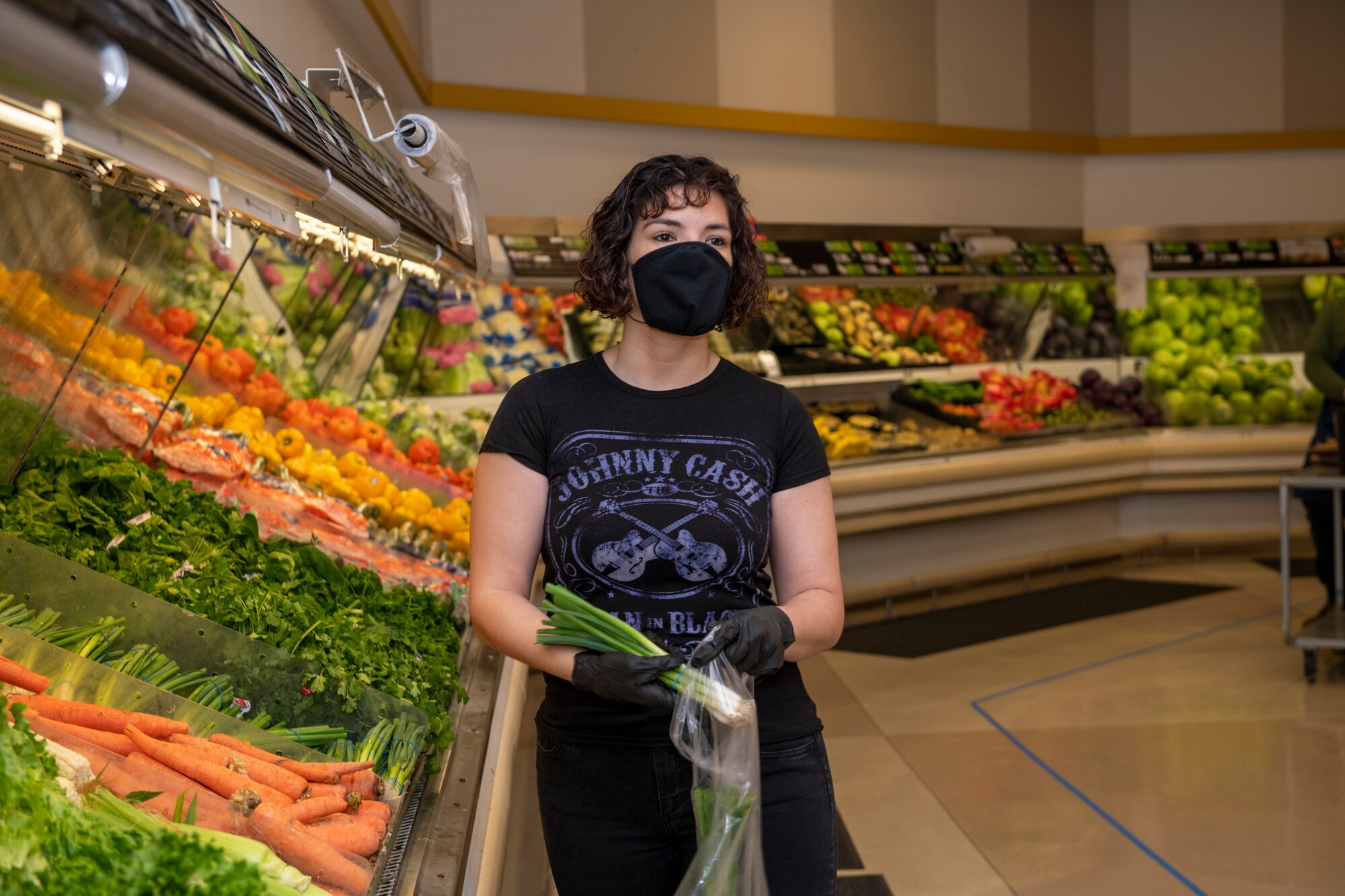 U.S. Air Force Senior Airman Nichole Krinberg, 60th Aerial Port Squadron air transportation journeyman, shops for vegetables April 16, 2020, inside the commissary at Travis Air Force Base, California. Since the coronavirus pandemic, some food and household goods such as toilet paper and paper towels have become increasingly scarce. (U.S. Air Force photo by Tech. Sgt. James Hodgman)