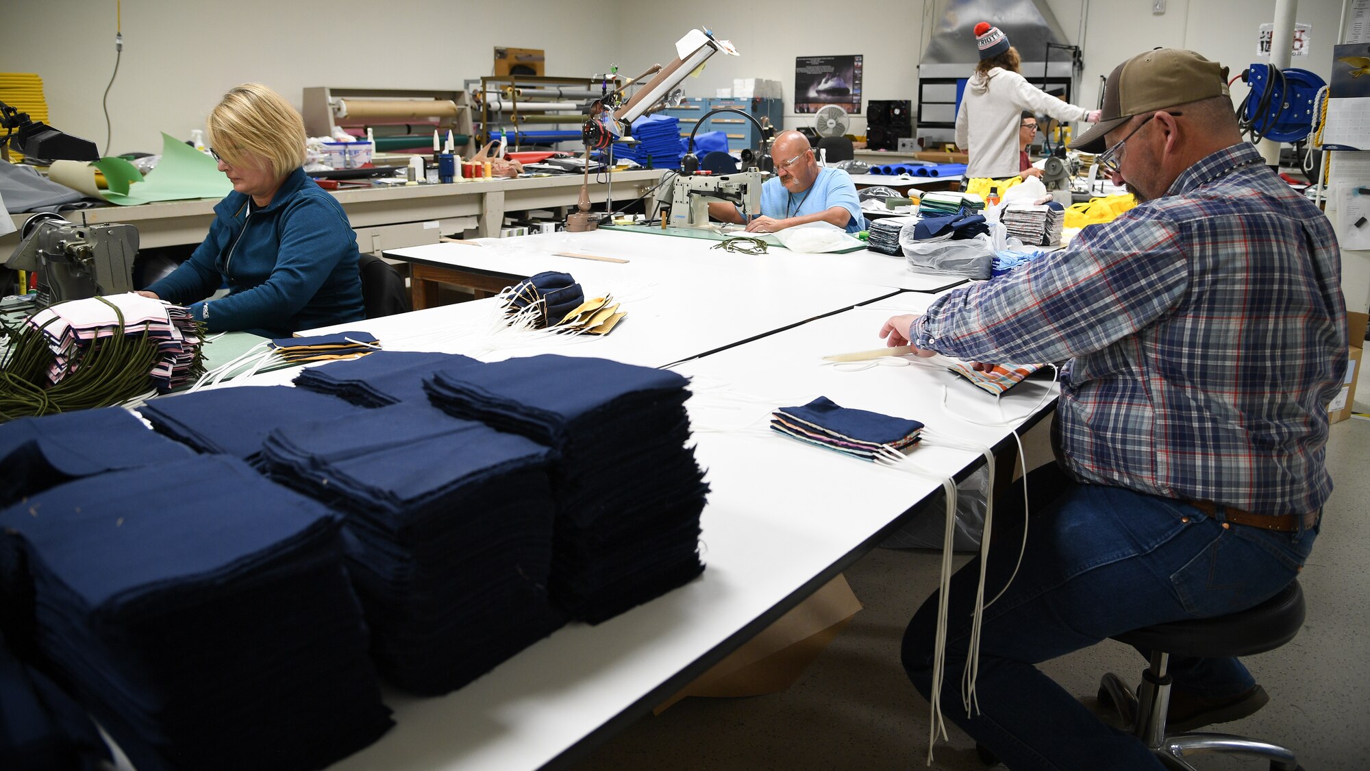 Aircrew Flight Equipment technicians with the 531st Armament Textile Shop make protective cloth masks at Hill Air Force Base, Utah, April 15, 2020. The shop is using their skill set and equipment to produce cloth face coverings for members of Team Hill. (U.S. Air Force photo by R. Nial Bradshaw)