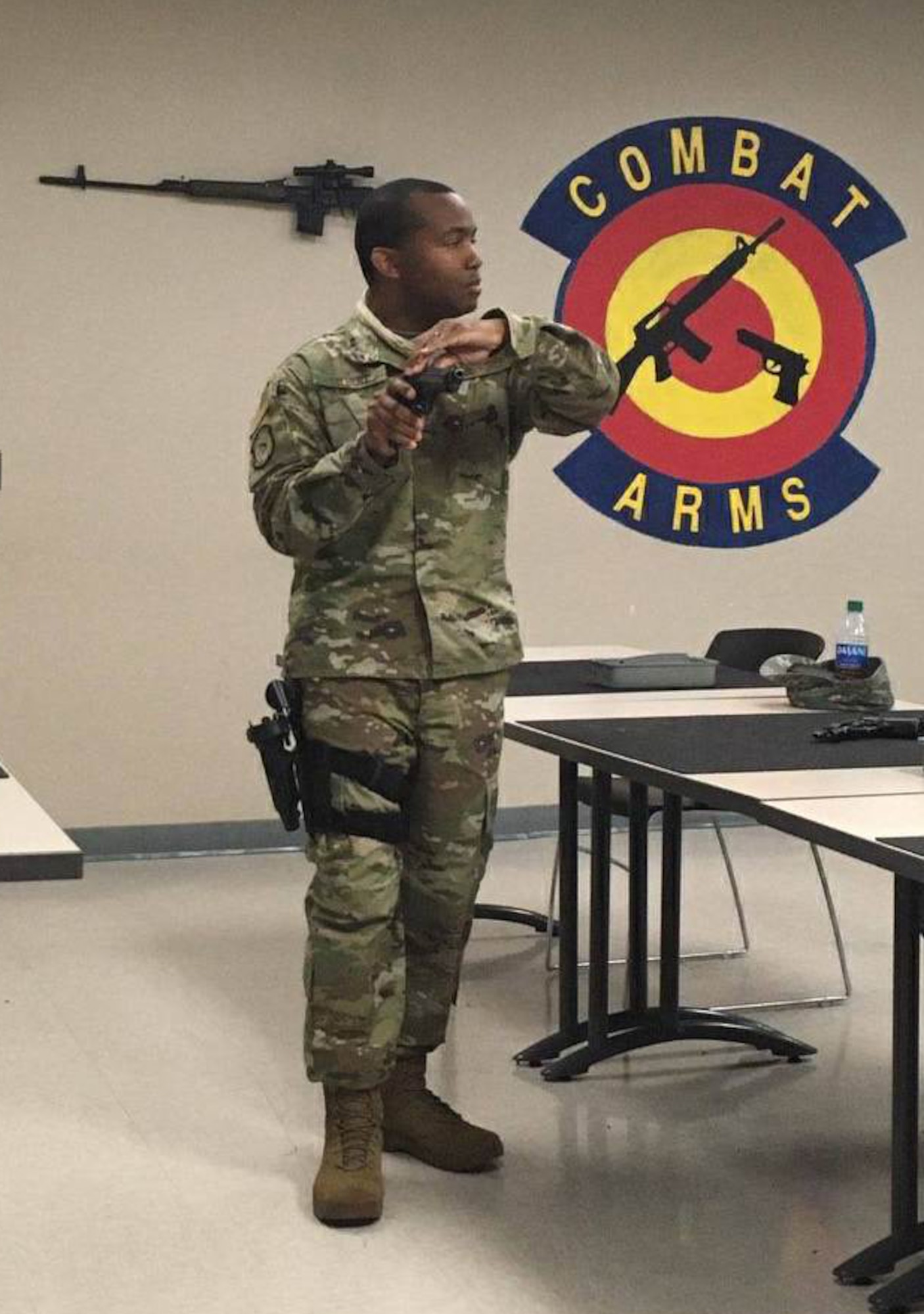 Tech. Sgt. Derrick Tolbert, 403rd Security Forces Squadron combat arms noncommissioned officer in charge, shows the proper procedures for handling a M9 firearm during a class April 9, 2020. The students were then taken to the indoor firing range to do the weapon qualification course at Keesler Air Force Base, Miss. (U.S. Air Force courtesy photo)