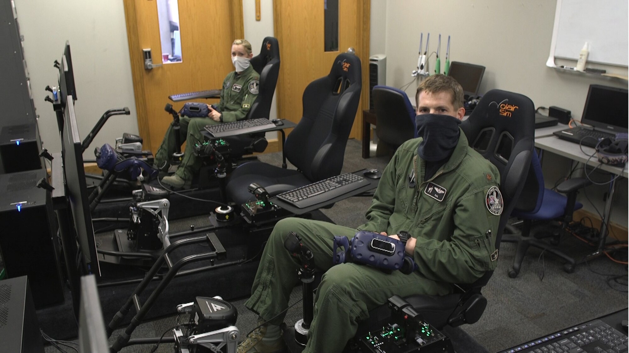 Maj. Meghan Booze and Maj. Matthew Ross, both pilots with the 4th Fighter Wing preparing to perform a Virtual Reality flyover during the iRacing NASCAR Pro Invitational hosted by the Richmond Raceway April 20, 2020.