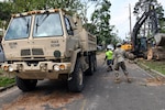 Louisiana National Guard members with the 225th Engineer Brigade help haul debris from tornadoes in Monroe, Louisiana, April 18, 2020, while also assisting with the COVID-19 response.