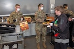 U.S. Army Pfc. Harold Taylor, signal support systems specialist, (left) and Spc. Jo England, communication specialist, Headquarters and Headquarters Company, 1st Battalion, 157th Infantry Regiment, Colorado Army National Guard, serve food to people experiencing homelessness during the COVID-19 outbreak at the Denver Rescue Mission, Denver, Colorado, April 20, 2020. Members of the Colorado National Guard are serving in a multitude of roles at the direction of Gov. Jared Polis to help state and local authorities combat the coronavirus pandemic. (U.S. Air National Guard photo by Senior Master Sgt. John Rohrer)