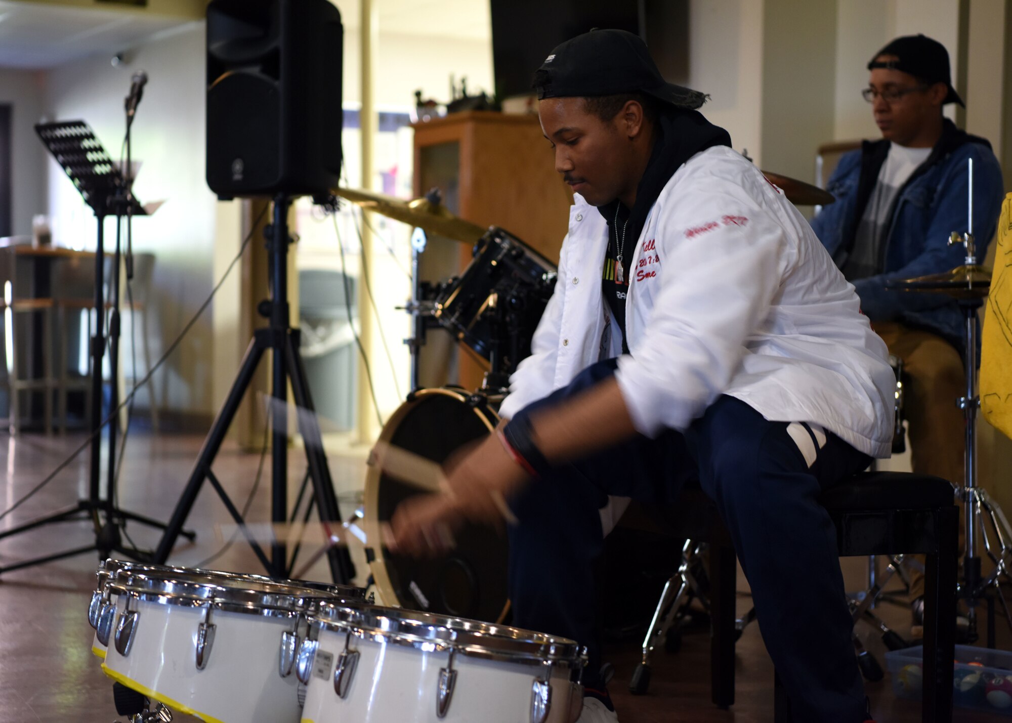 U.S. Air Force Airman 1st Class Israel Kelley, 316th Training Squadron student, plays the drums as part of the original piece “What You Mean” at Crossroads on Goodfellow Air Force Base, Texas, April 24. The original song by Kelley and Airman 1st Class William Barner, 315th Training Squadron student, was filled with banter, drums, and even a piano. (U.S. Air Force photo by Airman 1st Class Ethan Sherwood)