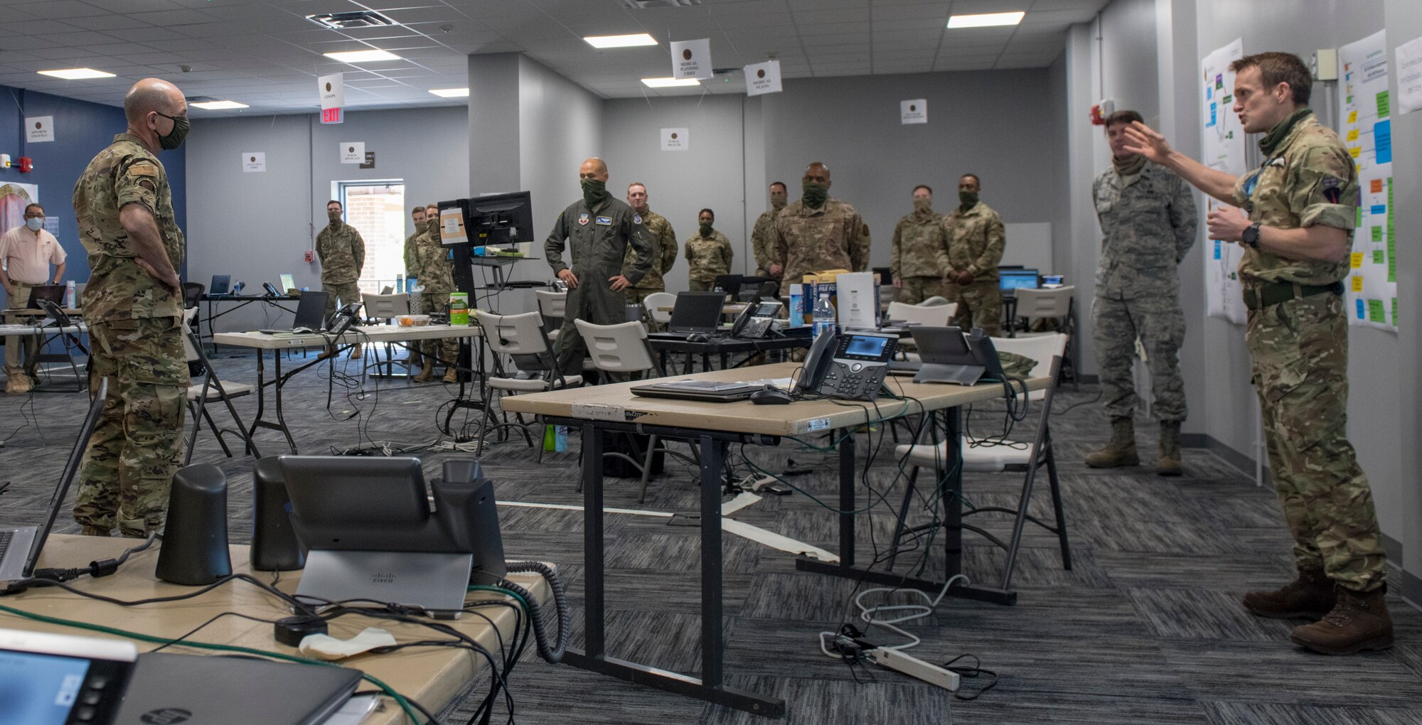 Photo of Gen. Mike Holmes, commander of Air Combat Command, receiving a brief the Task Force-Southeast Joint Operations Center