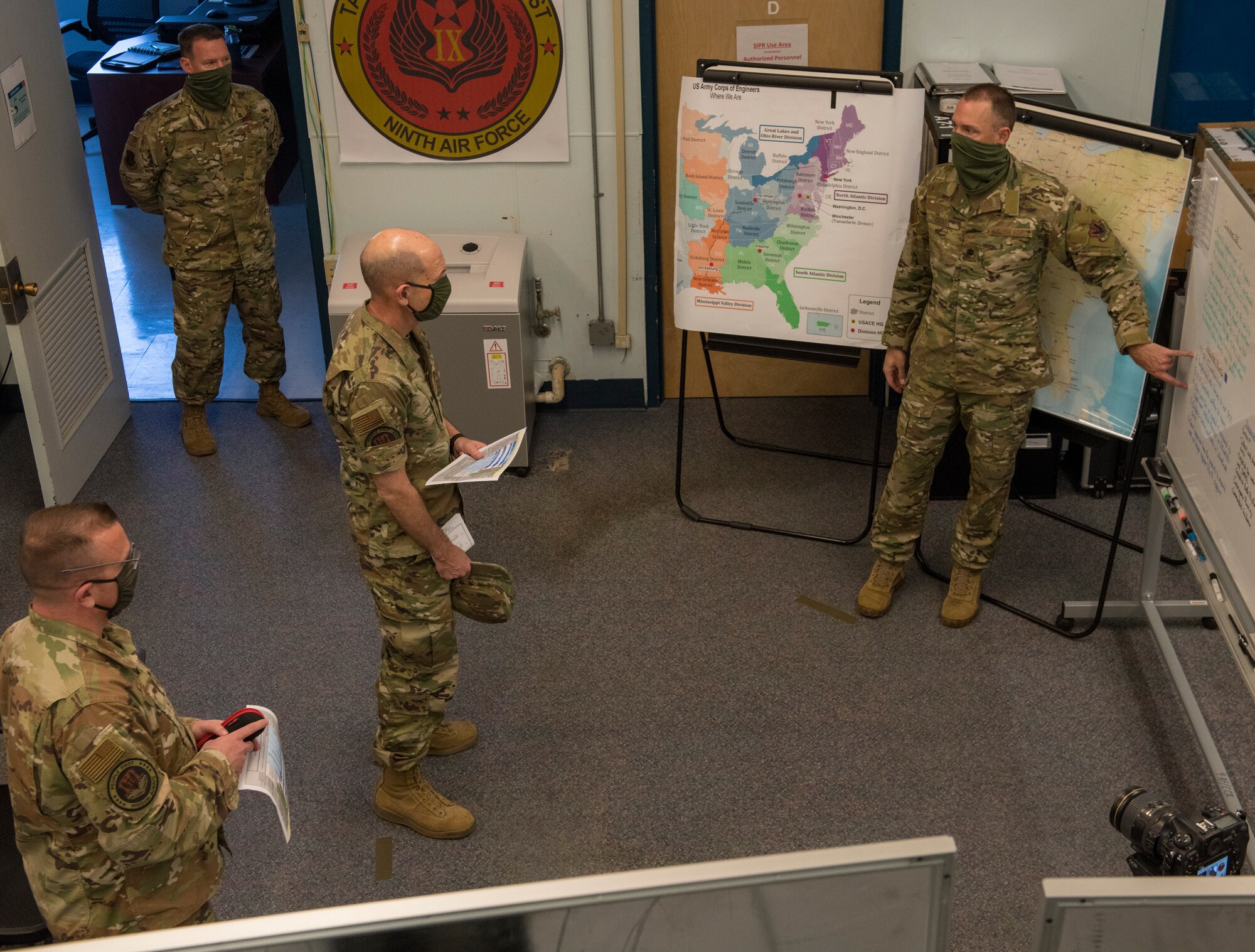 Photo of Gen. Mike Holmes, commander of Air Combat Command, receives a briefing from Task Force-Southeast members at Shaw Air Force Base