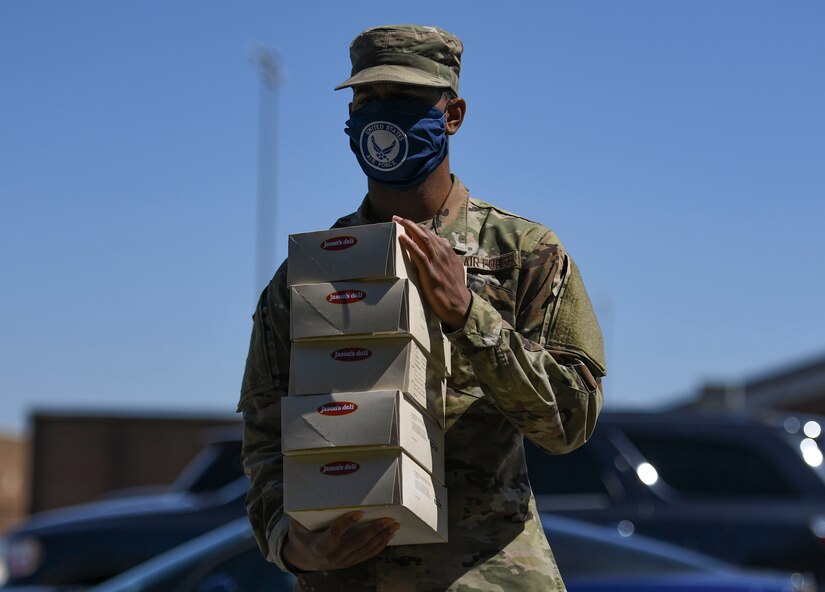 A U.S. Air Force Airman assigned to the 1st Fighter Wing carries boxed lunches back to his work area during a 1st Fighter Friday lunch at Joint Base Langley-Eustis, Virginia, April 22, 2020.