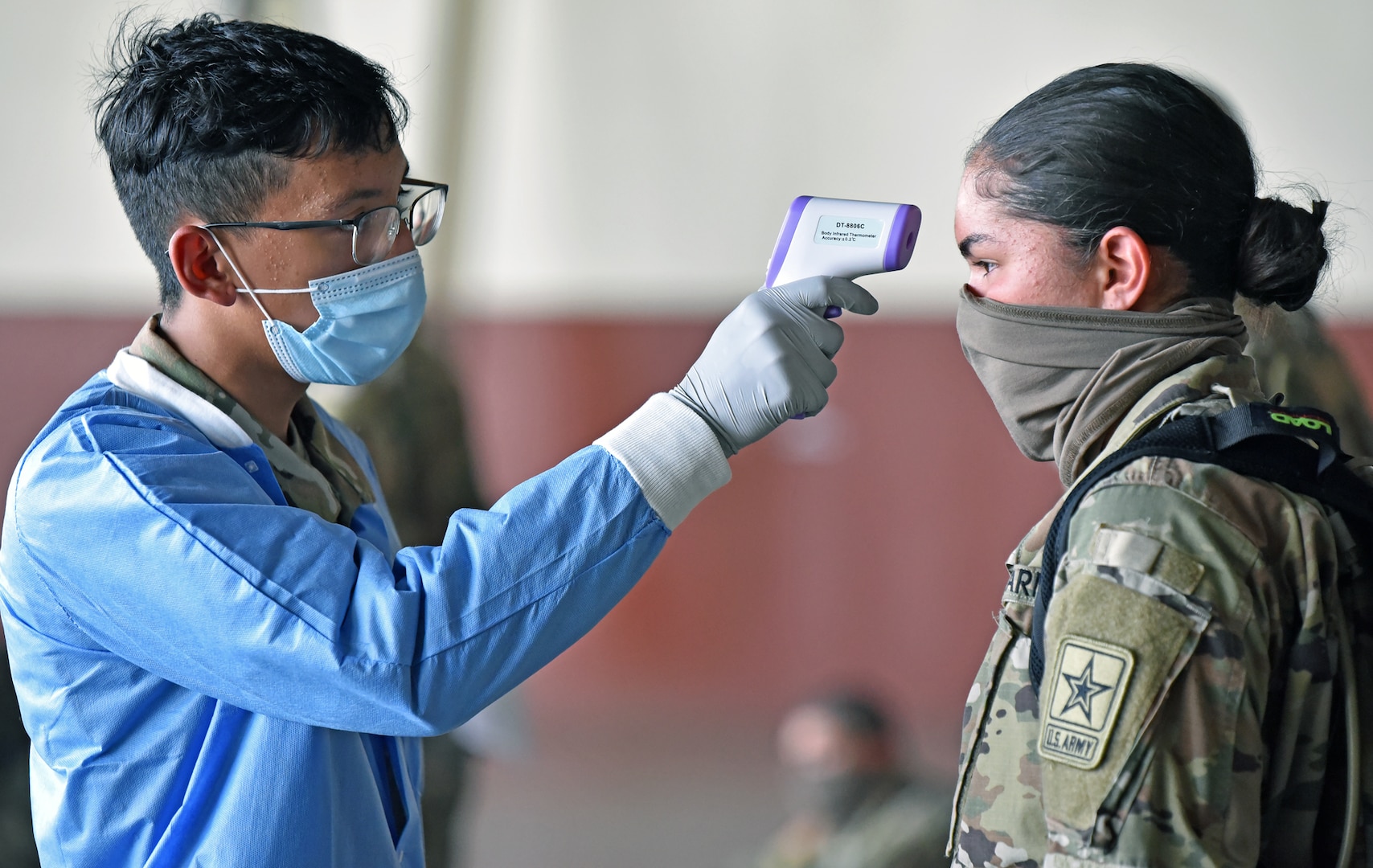 A Soldier has her temperature checked