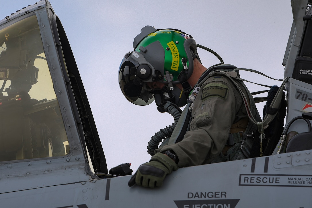 An A-10C Thunderbolt II pilot dones his helmet.