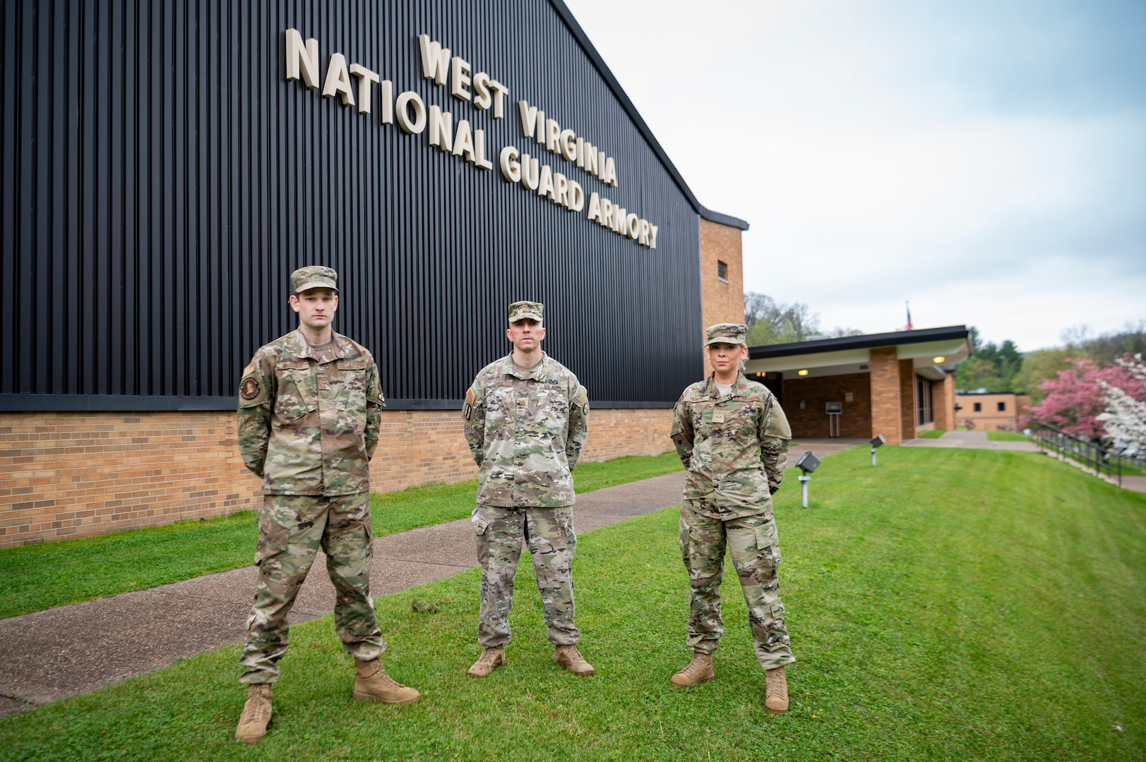 Senior Airman Will Wagstaff (left), Maj. Ryan Coss (center) and Senior Airman Carly Farmer pose for a photo outside the West Virginia National Guard Joint Forces Headquarters in Charleston, W.Va. Coss, Wagstaff and Farmer are serving as a part of Task Force Petersen, the task force dedicated to procuring and forecasting demand for critical personal protective equipment for the State of West Virginia's response to the ongoing COVID-19 pandemic. (U.S. Air National Guard photo by Staff Sgt. Caleb Vance.)