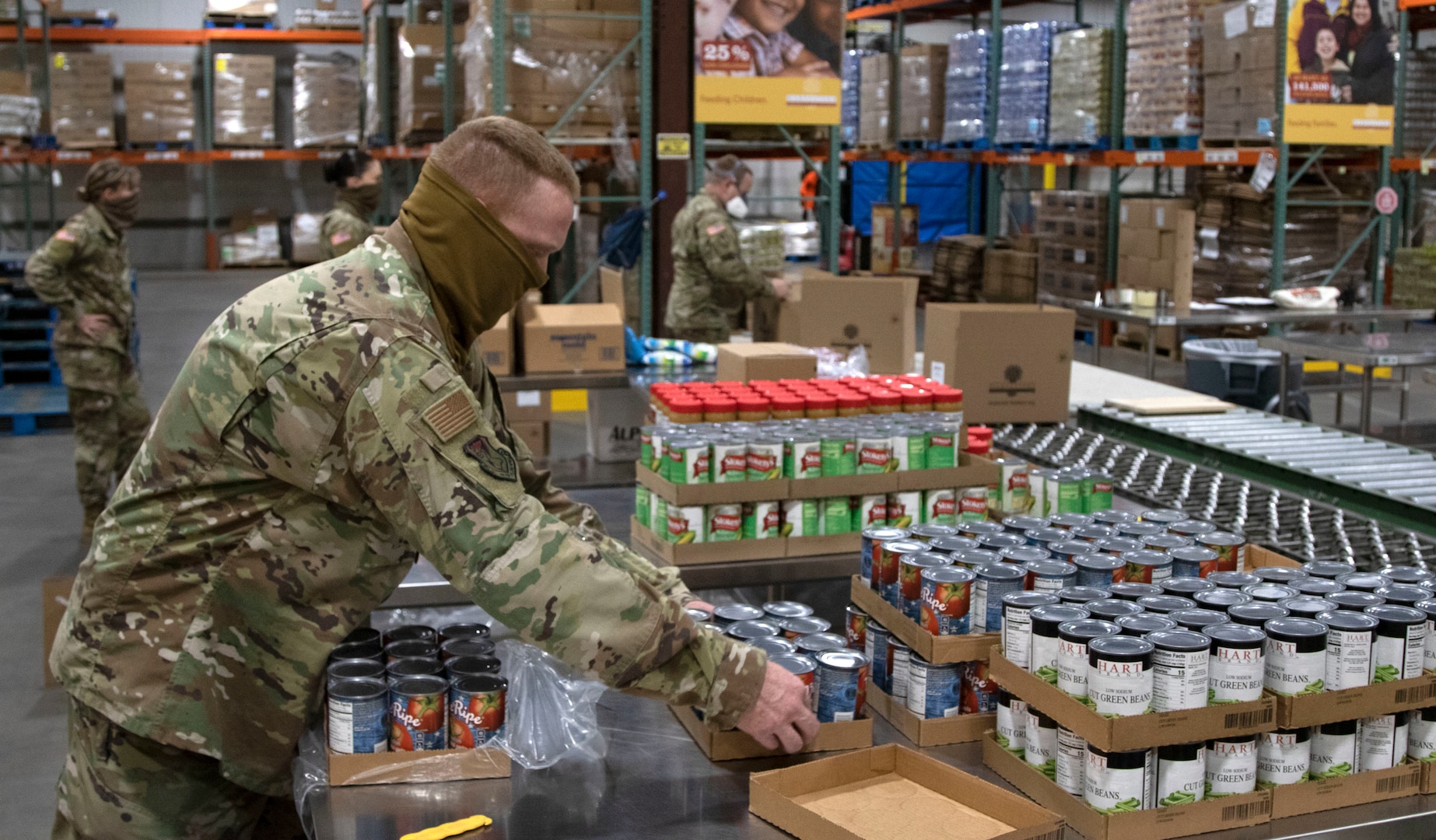 Soldiers and Airmen of the Kansas National Guard help pack food at Harvesters in Topeka, Kansas, April 22, 2020. The food will be shipped to families across the state.