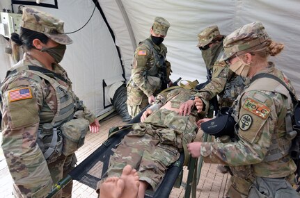 Basic Officer Leadership Course students practice moving a simulated causality into a field hospital while practicing tactical dispersion and social distance during a field training exercise at Joint Base San Antonio-Camp Bullis April 14.
