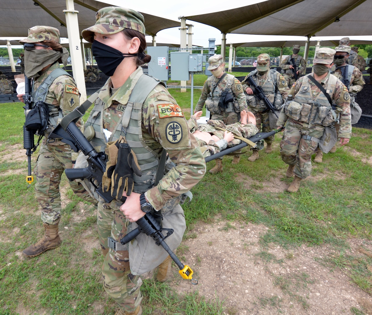 Basic Officer Leadership Course students move a simulated causality while adhering to tactical dispersion during the COVID-19 response at a field training exercise held at Joint Base San Antonio-Camp Bullis April 14.