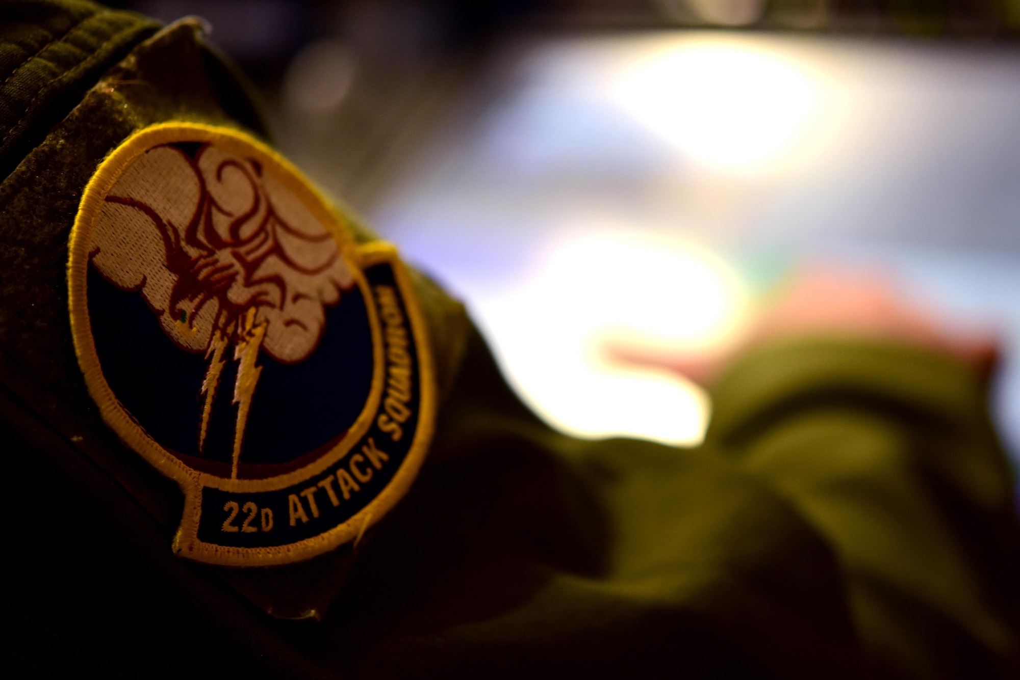 A 22nd Attack Squadron patch can be seen on the shoulder of an MQ-9 Reaper operator within a Ground Control Station at Creech Air Force Base, Nevada, April 15, 2020. The 22nd ATKS is one of several attack squadrons under the 432nd Wing/432nd Air Expeditionary Wing, a unit dedicated to 24/7 MQ-9 operations taking place around the world. (U.S. Air Force photo by Airman 1st Class William Rio Rosado)