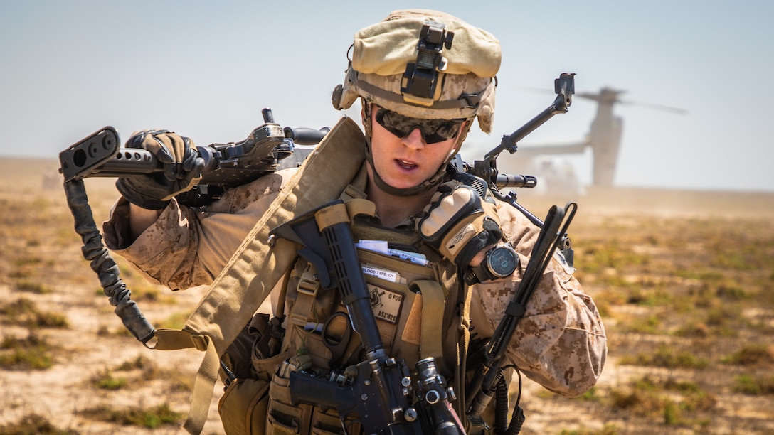 A U.S. Marine relays a message over a radio during a tactical recovery of aircraft and personnel exercise on Karan Island, Kingdom of Saudi Arabia, April 23, 2020.