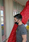 Corporal Jose RiveraMartinez, S-6 Communications, helps move and evening gown-clad mannequin into the new NMCRS Thrift Store location aboard Marine Corps Logistics Base Barstow, Calif., April 18.