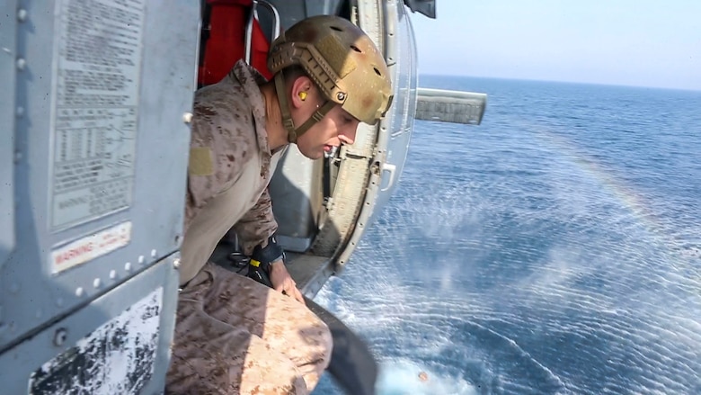 A reconnaissance Marine assigned to the Maritime Raid Force, 26th Marine Expeditionary Unit, prepares to jump into the ocean during helocasting training in the U.S. Navy's 5th Fleet Area of Responsibility, April 23, 2020. The 26th MEU is deployed to the U.S. 5th Fleet area of operations in support of naval operations to ensure maritime stability and security in the Central Region, connecting the Mediterranean and Pacific through the Western Indian Ocean and three strategic choke points. (U.S. Marine Corps photo by Cpl. Tanner Seims)
