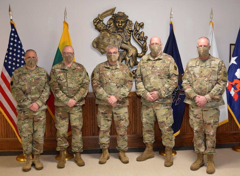 Senior leaders of the Pa. National Guard pose for a picture in front of the U.S., Lithuania and Pennsylvania flags, while observing COVID-19 mitigation practices, to mark the 27th anniversary of State Partnership Program between Pennsylvania and Lithuania.