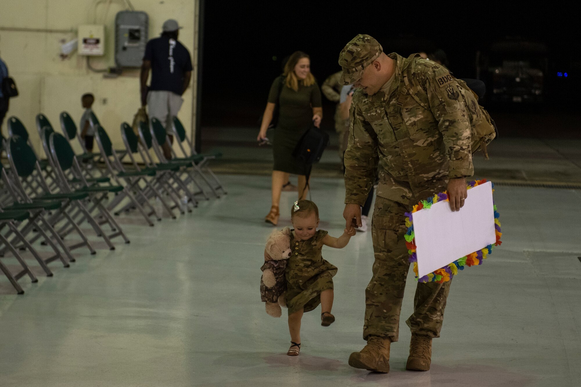 Airman walks with young daughter