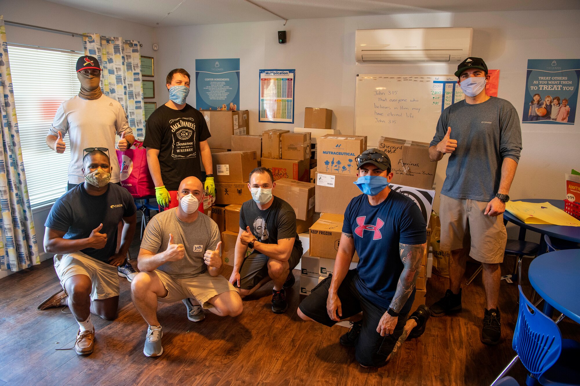 Members of the 821st Contingency Response Group pose for a photo April 24, 2020, in front of boxes of nonperishable food at The Leaven after-school program building in Vacaville, California. Over the two week-long food drive, the Airmen collected more 80 boxes of items such as canned fruit, vegetables and proteins; grains and cereals; snacks and juice boxes for children. (U.S. Air Force photo by Tech. Sgt. David W. Carbajal)