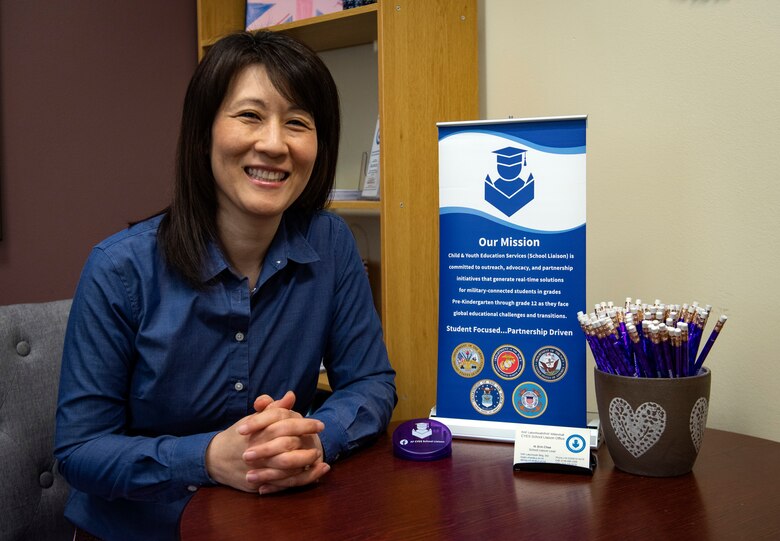 Erin Chae, CYES Supervisory School Liaison Specialist, poses for a photo in her office at Royal Air Force Lakenheath, April 23, 2020. The School Liaison Office serves 3,418 students assigned to RAF Mildenhall and RAF Lakenheath and helps advocate, advise, and alliance-build for families, schools, commanders, and US/UK communities, providing opportunities and information necessary for children to succeed in any academic environment. (U.S. Air Force photo by Airman 1st Class Madeline Herzog)