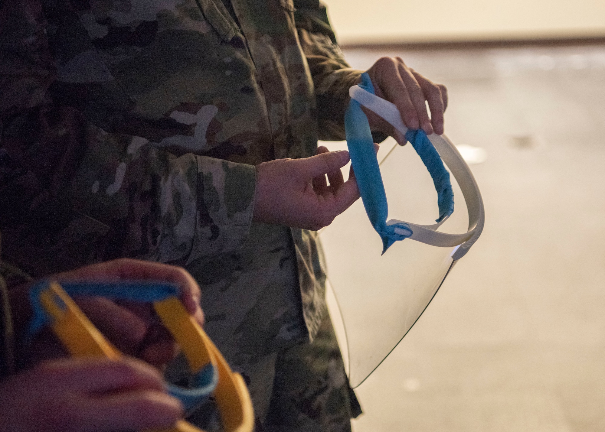 Airmen from the 18th Security Forces Squadron receive 3D printed face shields April 10, 2020, at Kadena Air Base, Japan. The face shields are used to protect front-line workers, like security forces, who are interfacing with a large amount of people per day.