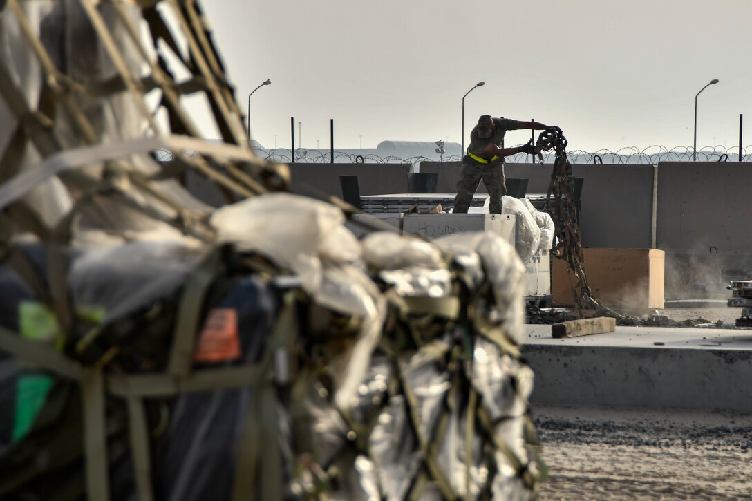 Photo of Airmen working on cargo nets