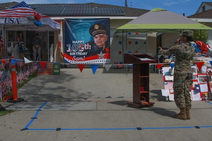 Spc. Raiyven Herne, a vocalist with the 40th Infantry Division Band, California National Guard, sings happy birthday to Lt. Col. Sam Sachs, a World War II veteran, during his 105th birthday celebration in Lakewood, California, April 26, 2020.