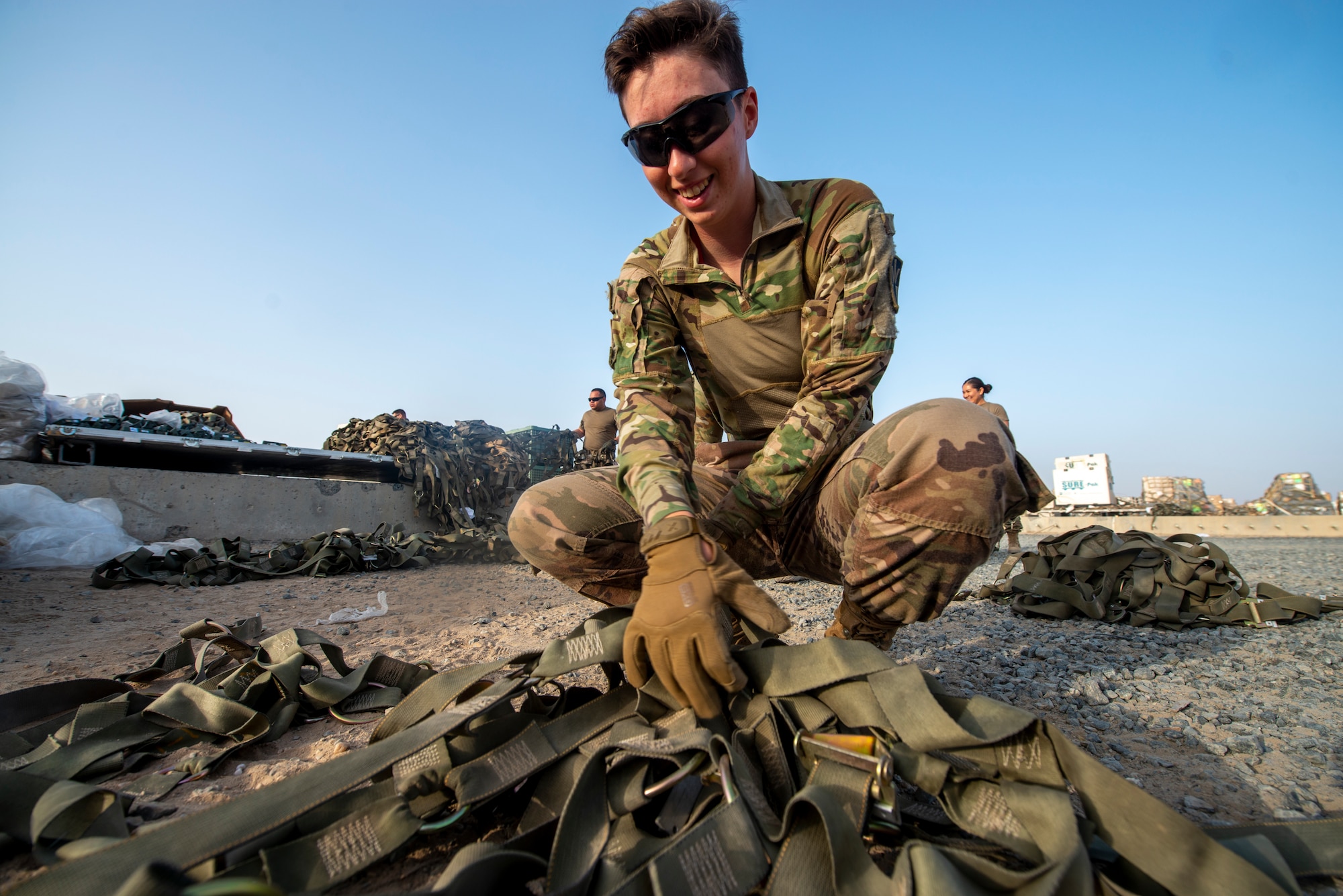 Photo of Airmen working on cargo nets