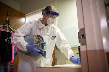 A member of the Oklahoma National Guard disinfects a bathroom sink at a long-term health care facility in McAlester, Oklahoma, April 22, 2020. The Guard disinfected floors, walls and commonly touched surfaces to help prevent the spread of COVID-19.