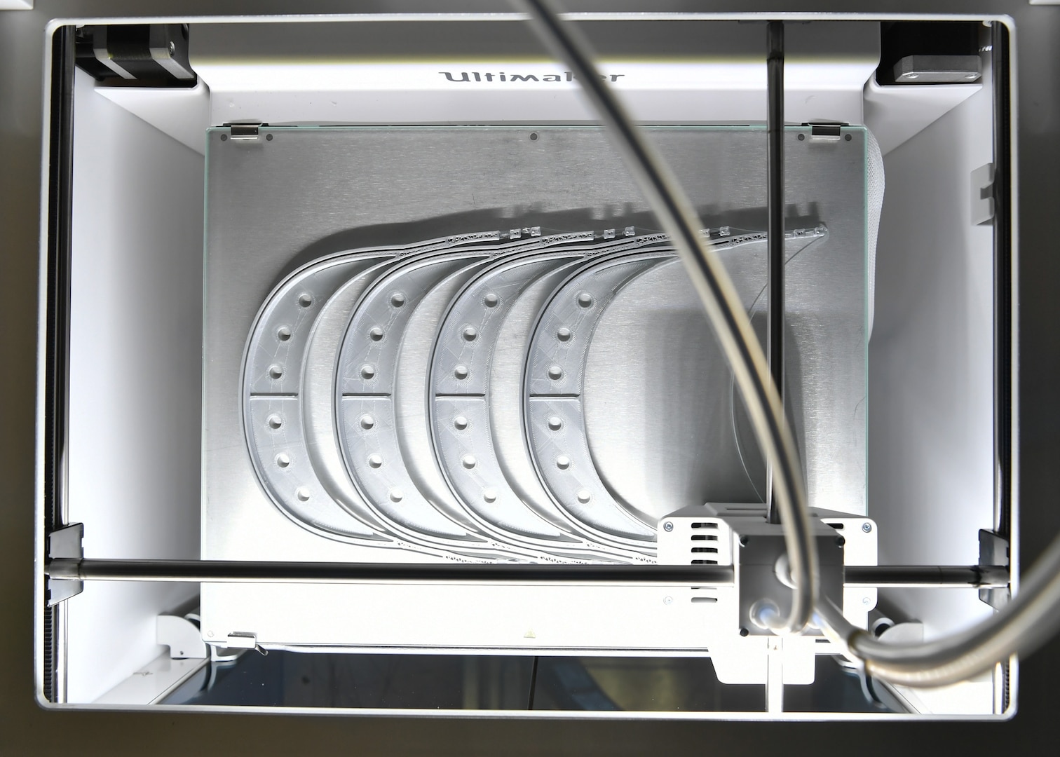 Naval Surface Warfare Center Carderock Division’s Milton Perez-Cruz and his coworkers use the Ultimaker S5 3D printer to produce face-shield frames before assembling the face shields in April 2020.