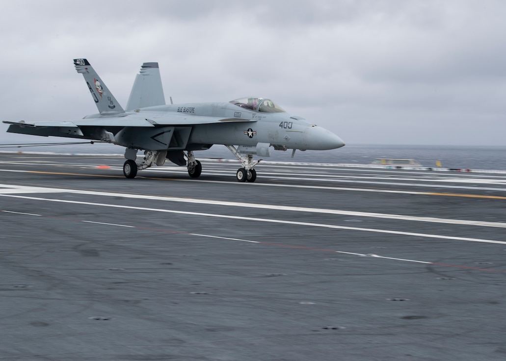 An F/A-18E Super Hornet, attached to the "Blue Blasters" of Strike Fighter Squadron (VFA) 34, lands aboard USS Gerald R. Ford's (CVN 78) flight deck during flight operations in the Atlantic Ocean, March 21, 2020. Ford is currently underway conducting carrier qualifications.