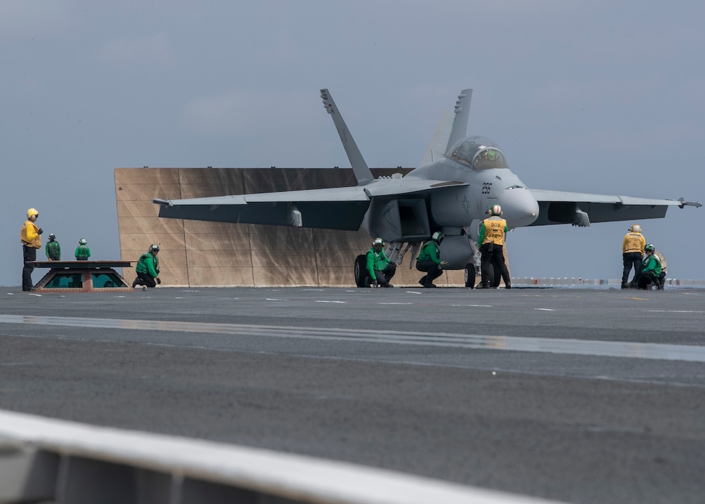 Sailors assigned to USS Gerald R. Ford's (CVN 78) air department, prepare to launch an F/A-18F Super Hornet, attached to the "Gladiators" of Strike Fighter Squadron (VFA) 106, on Ford's flight deck during flight operations March 29, 2020. Ford is underway in the Atlantic Ocean conducting carrier qualifications.