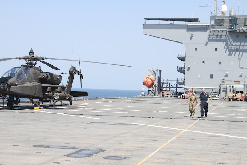 Lieutenant Colonel Margarat Stick, the commander of the Multi-Functional Aviation Task Force walks with Captain Scott Hattaway, the Captain of the USS Puller on April 16, 2020 in the Persian Gulf. Stick representing the U.S. Army Aviation and Hattaway representing the U.S. Navy worked together to conduct a joint at sea training exercise. (U.S. Army photo by SGT. Andrew Winchell)