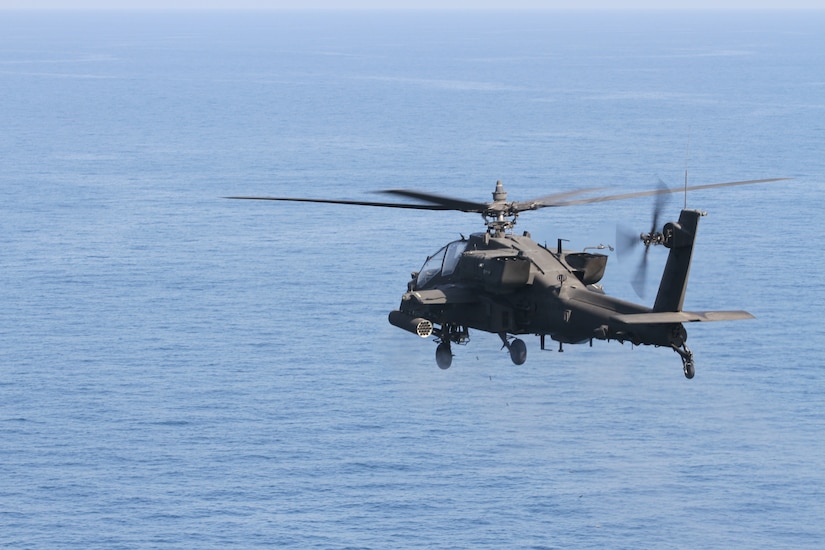 An AH-64E Apache gunship fires its 30mm cannon during a live fire training exercise on April 16, 2020 in the Persian Gulf. . The Apache pilots engage floating targets to hone their aerial gunnery skills. (U.S. Army photo by SGT. Andrew Winchell)