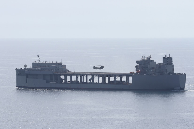 A Chinook lands on the deck of the U.S.S. Lewis B. Puller during a training exercise on April 15, 2020 in the Persian Gulf. The U.S. Army and the U.S. Navy work together to increase both their forces capabilities during this training exercise. (U.S. Army photo by Sgt. Andrew Winchell)