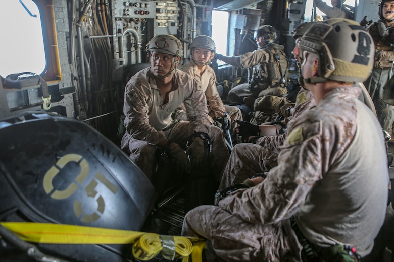 Marines assigned to the Maritime Raid Force, 26th Marine Expeditionary Unit, sit on a combat rubber raiding raft inside of a CH-53E Super Stallion during helocasting training in the 5th Fleet area of operations, April 23, 2020. The 26th MEU is deployed to the U.S. 5th Fleet area of operations in support of naval operations to ensure maritime stability and security in the Central Region, connecting the Mediterranean and Pacific through the Western Indian Ocean and three strategic choke points. (U.S. Marine Corps photo by Cpl. Nathan Reyes)