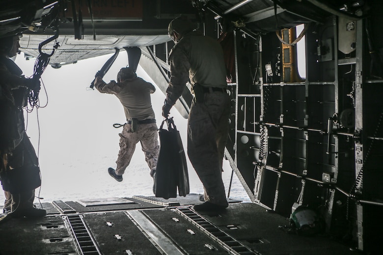 Marines assigned to the Maritime Raid Force, 26th Marine Expeditionary Unit, jump into the ocean from a CH-53E Super Stallion during helocasting training in the 5th Fleet area of operations, April 23, 2020. The 26th MEU is deployed to the U.S. 5th Fleet area of operations in support of naval operations to ensure maritime stability and security in the Central Region, connecting the Mediterranean and Pacific through the Western Indian Ocean and three strategic choke points. (U.S. Marine Corps photo by Cpl. Nathan Reyes)