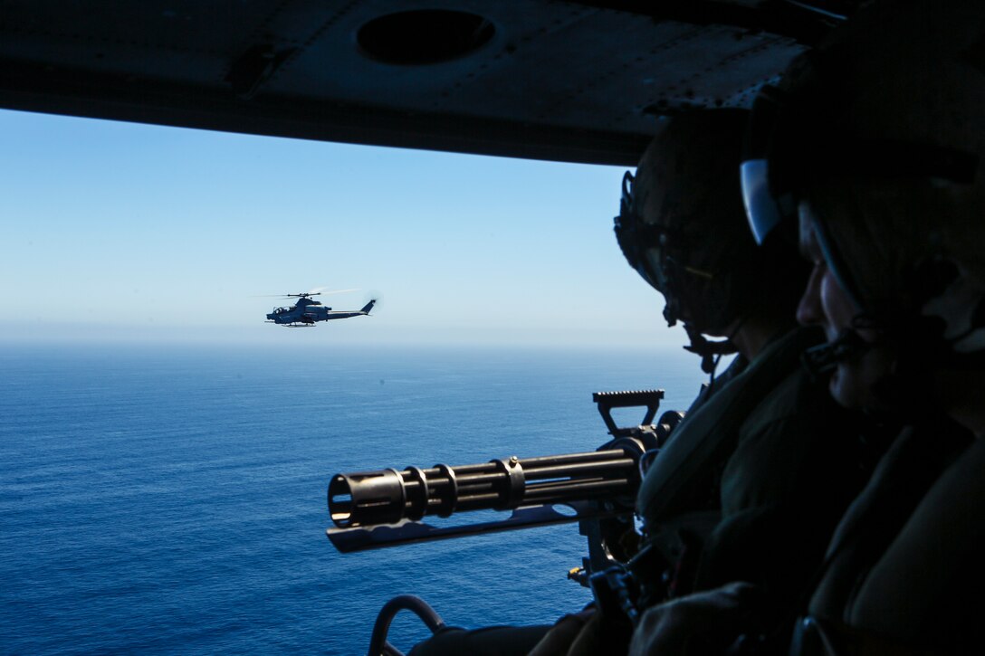 U.S. Marine Corps Sgt. Eric Landin, a UH-1Y Huey crew chief with Marine Light Attack Helicopter Squadron 469, Marine Aircraft Group 39, 3rd Marine Aircraft Wing (MAW), observes a AH- 1Z SuperCobra during a sustainment mission on Marine Corps Air Station Camp Pendleton, Calif., April 22, 2019. The training mission was held amid the COVID-19 crisis as a means of maintaining operational capabilities and assuring 3rd MAW remains ready for the mission. (U.S. Marine Corps photo by Lance Cpl. Jaime Reyes)