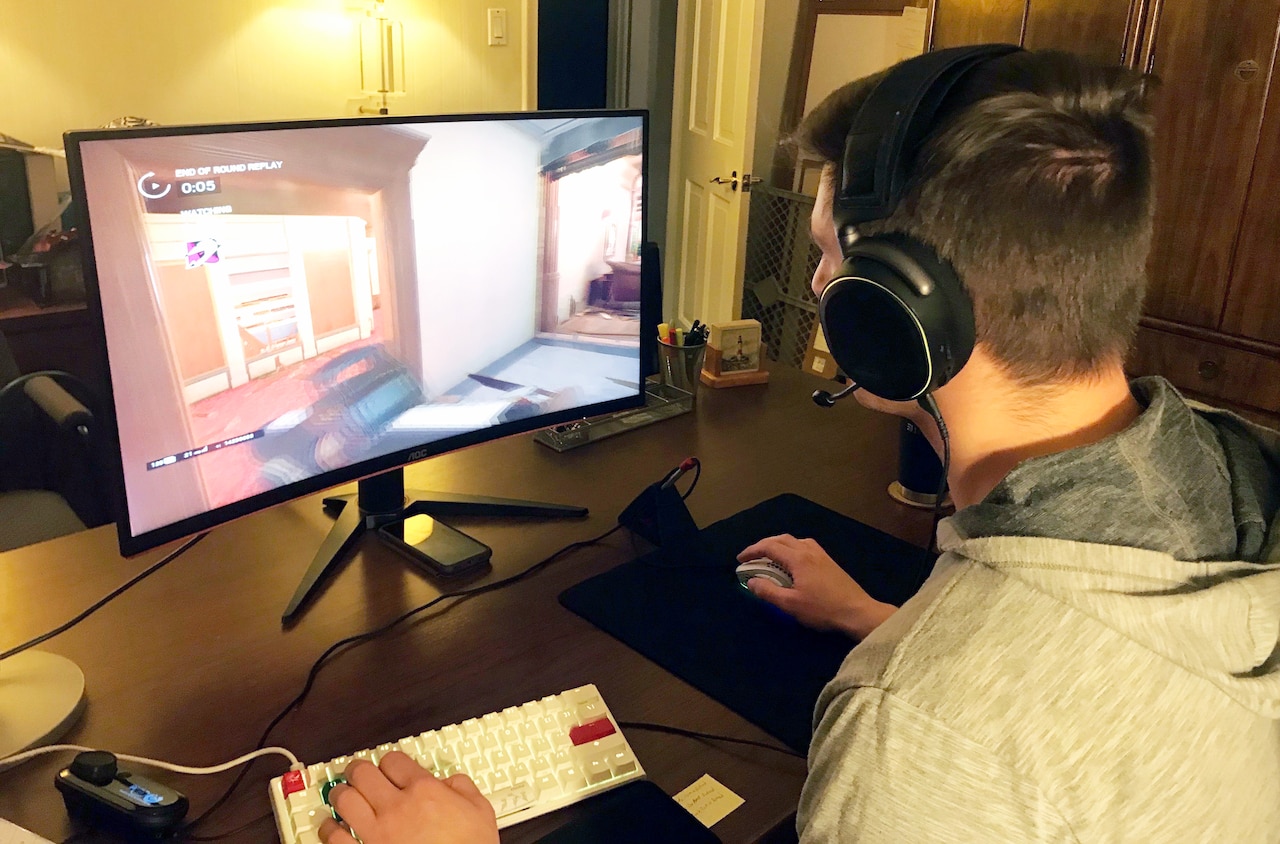 A cadet playing Tom Clancy’s Rainbow Six Siege on a computer.