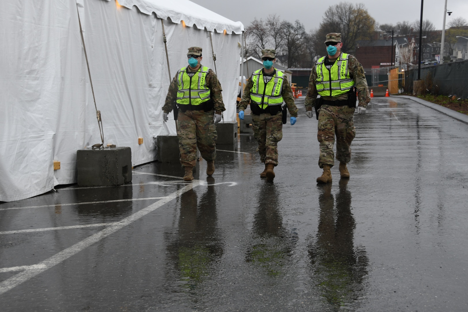 Security Forces and Military Police from the Massachusetts National Guard patrol a COVID-19 testing site for the homeless to protect supplies, patients and medical staff, Springfield, Massachusetts, April 21, 2020. Security Forces Airmen of the 104th Fighter Wing and Military Police Soldiers of the 211th Military Police Battalion, 747th Military Police Company, are working jointly as a quick reaction force in response to COVID-19.