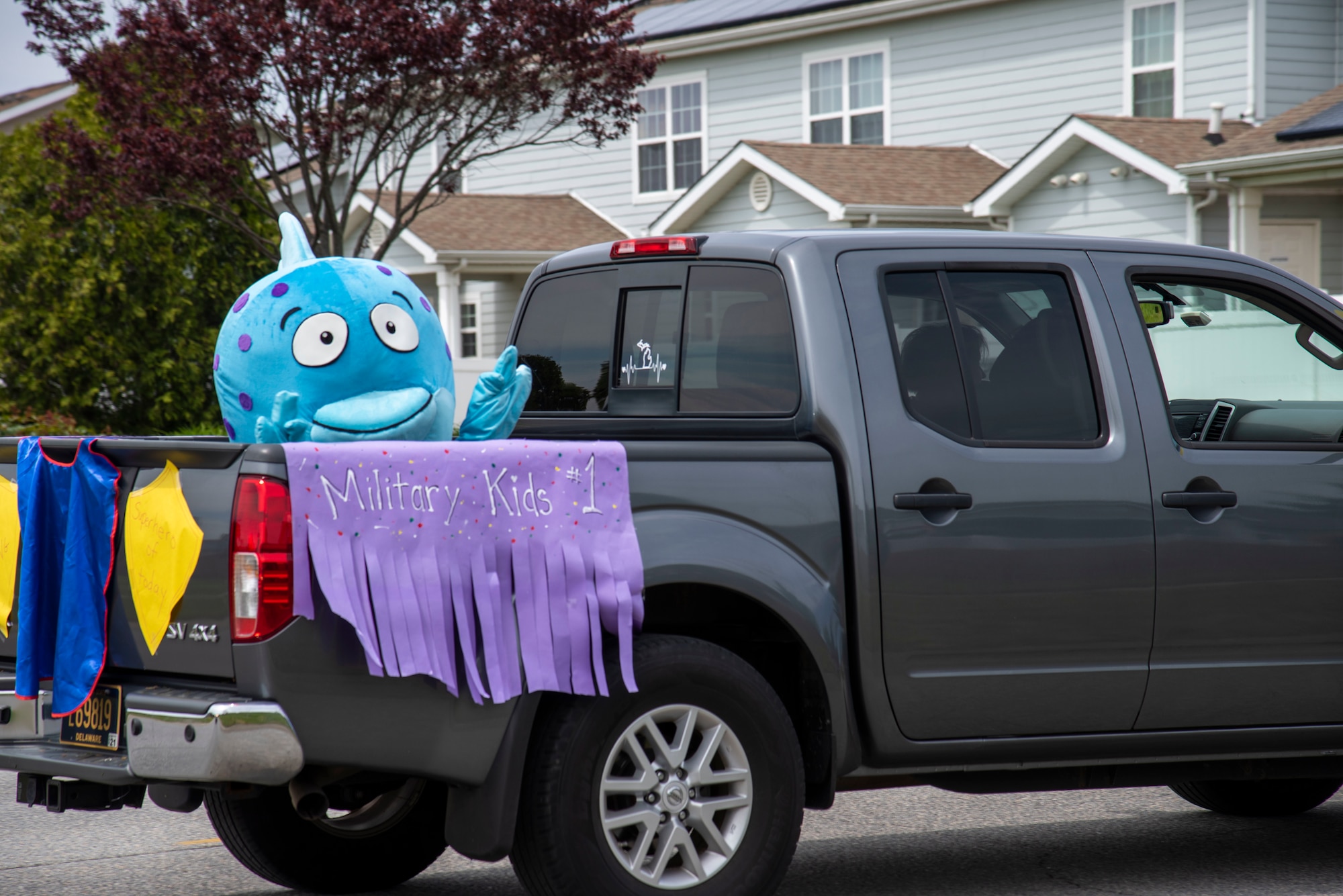 Dover Air Force Base school district mascot, Bubbles, waves to families during a "Teachers' Parade" April 28, 2020, at Dover Air Force Base, Delaware. Despite the closure of Delaware school due to COVID-19, Teachers from Welch Elementary and Dover Air Base Middle School found time to celebrate Month of the Military Child which dedicates the month of April to honoring the sacrifices made by military families. (U.S. Air Force photo by Airman 1st Class Jonathan Harding).