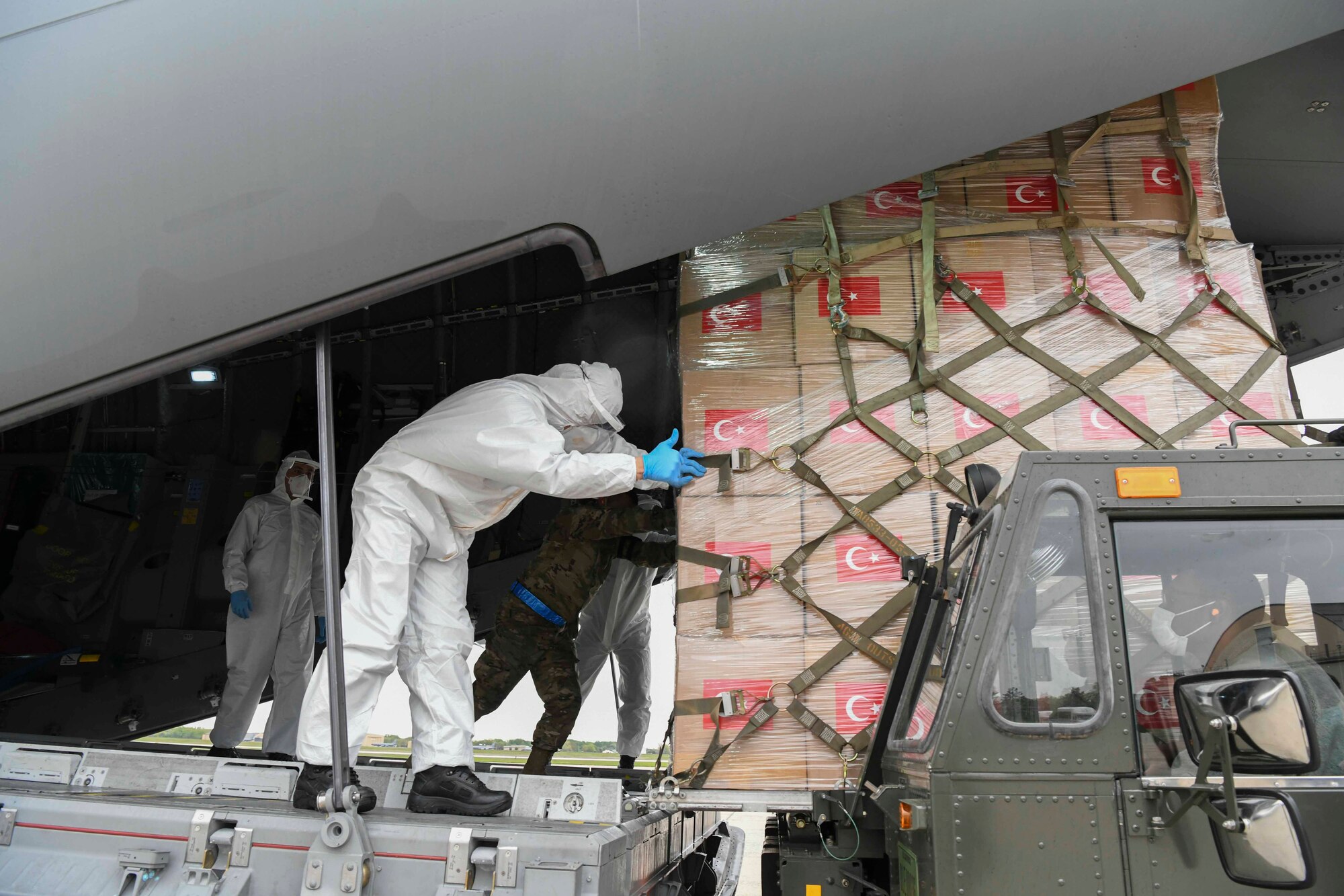 Turkish and U.S. Air Force crew members work together to unload a Turkish Airbus A400M Atlas at Joint Base Andrews, Md., Apr. 28, 2020. The aircraft landed at JBA with medical supplies to respond to the coronavirus pandemic, with Airmen assigned to the 89th Airlift Wing helping unload the materials. (U.S. Air Force photo by Airman 1st Class Spencer Slocum)