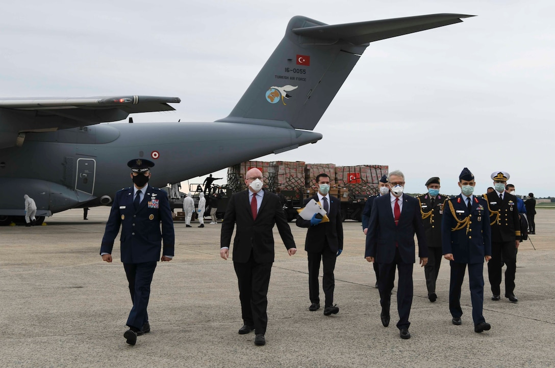 U.S. and Turkish leadership walk away from a Turkish Airbus A400M Atlas filled with medical supplies at Joint Base Andrews, Md., Apr. 28, 2020. The Turkish Ambassador to the U.S., the Turkish Defense Attaché to the U.S., and other Turkish Embassy staff members greeted the arriving Turkish crew when the plane arrived as well as a State Department delegation. (U.S. Air Force photo by Airman 1st Class Spencer Slocum)