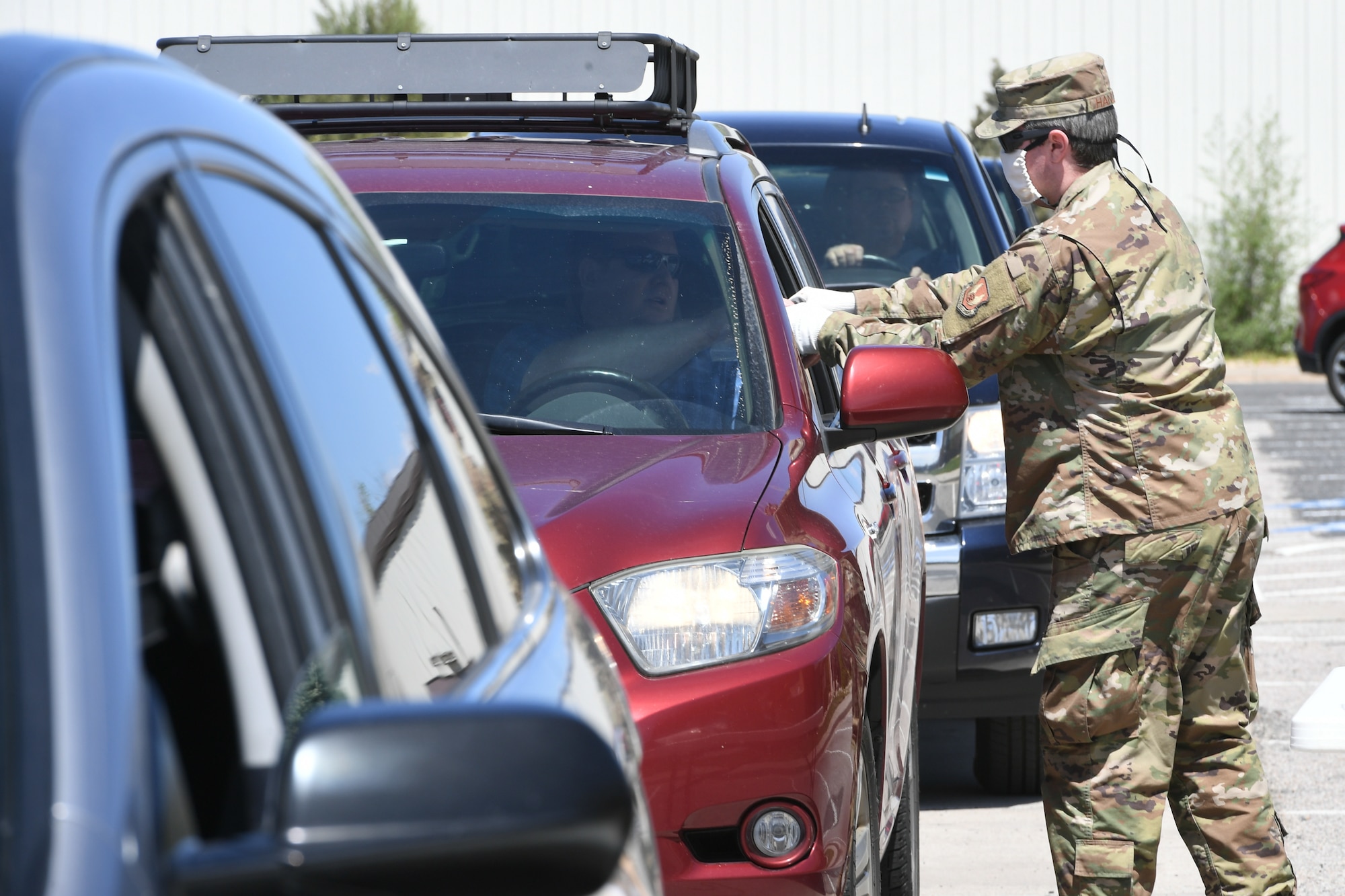 Tech. Sgt. Brian Hanley, 75th Logistics Readiness Squadron, hands out cloth masks to military and civilian Airmen April 28, 2020, at Hill Air Force Base, Utah. Around 4,000 masks, most donated from nearby communities and also from the 531st Armament Textile Shop, were given out to Team Hill to keep safe and healthy during the COVID-19 pandemic. (U.S. Air Force photo by Cynthia Griggs)