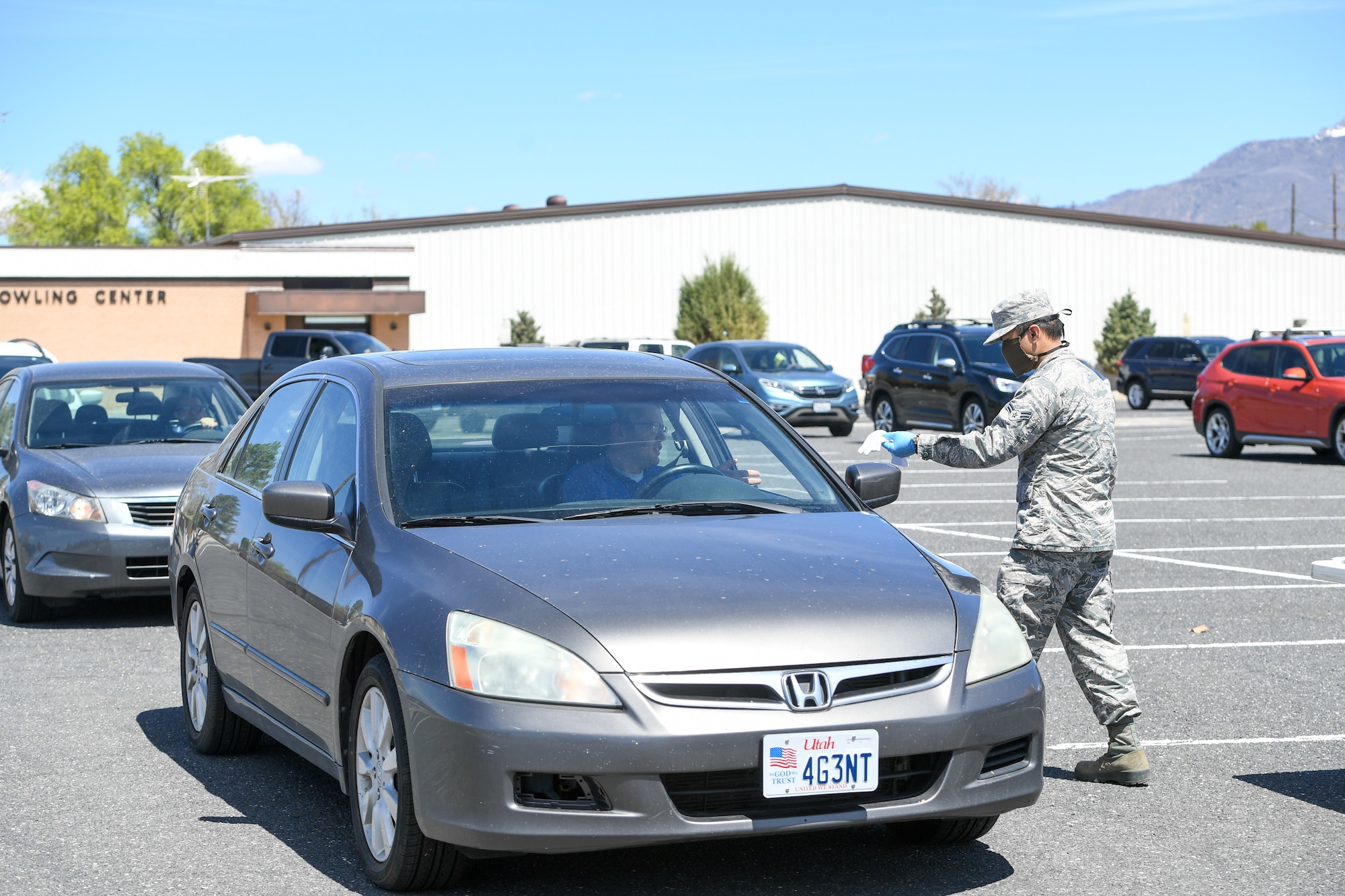 Airman 1st Class Jhon Espiritu, 75th Logistics Readiness Squadron, hands out masks to military and civilian Airmen April 28, 2020, at Hill Air Force Base, Utah. Around 4,000 masks, most donated from nearby communities and also from the 531st Armament Textile Shop, were given out to Team Hill to keep safe and healthy during the COVID-19 pandemic. (U.S. Air Force photo by Cynthia Griggs)