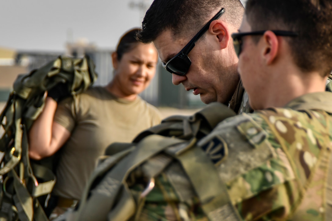 Photo of Airmen working on cargo nets