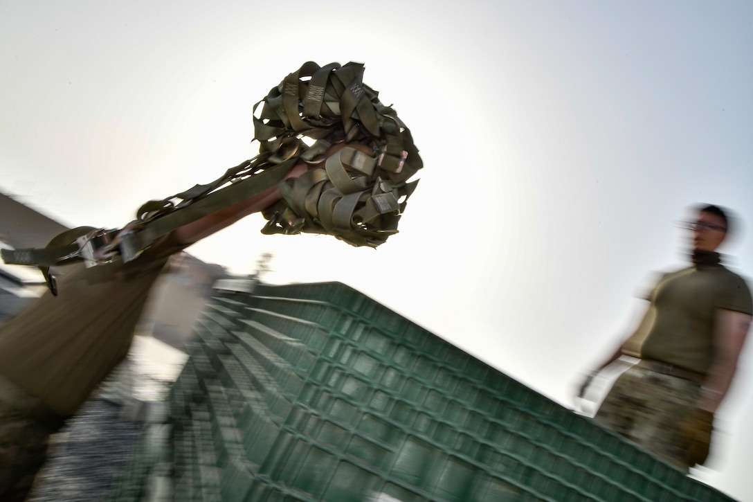 Photo of Airmen working on cargo nets