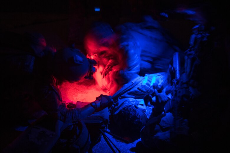 operators under a blue and red light giving care to a patient