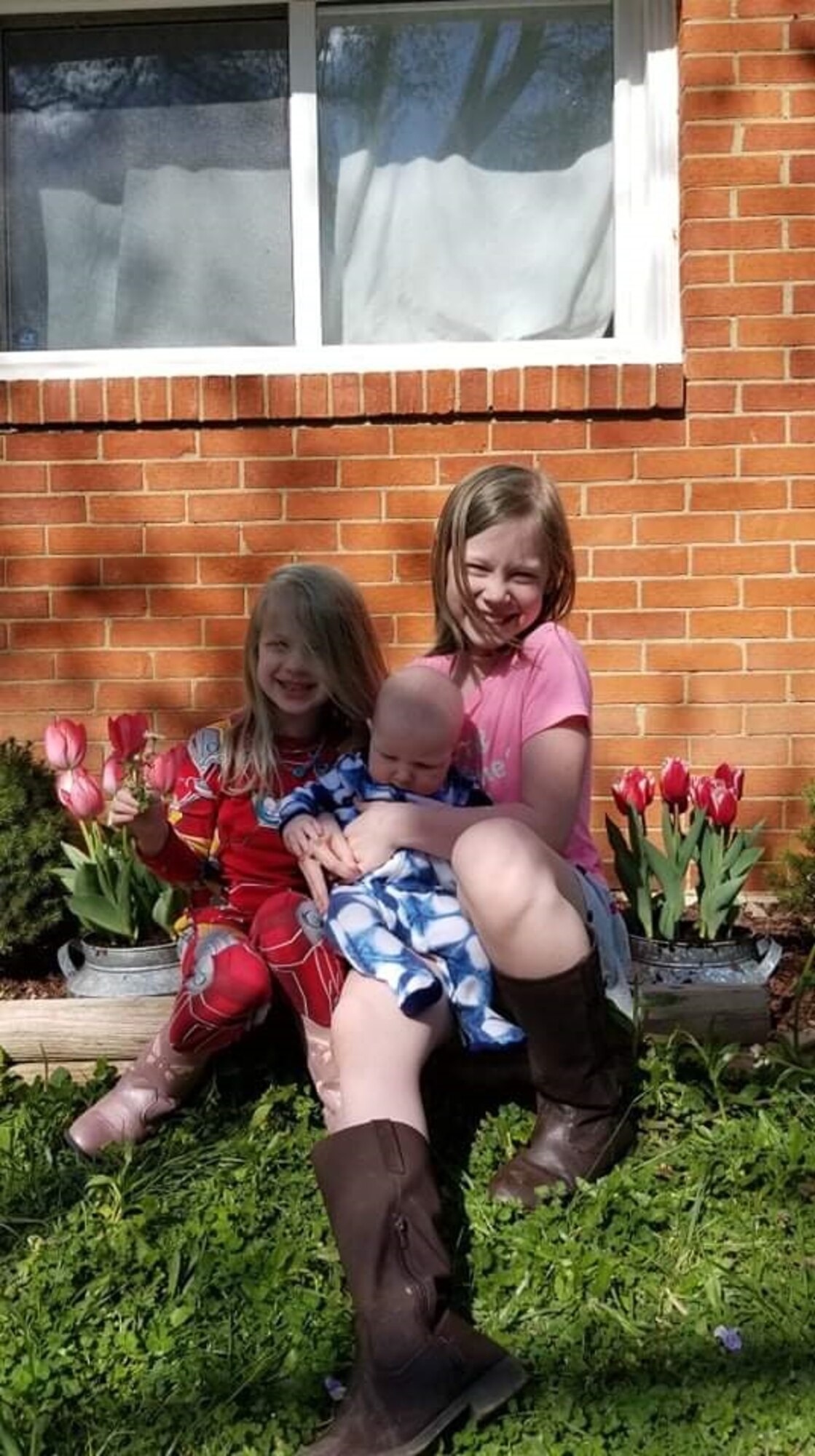 Isabella, five, and Alyssa, 11, hold their newborn sister, Emily, April 4, 2020, at their home in Virginia. The photo serves as Staff Sgt. Timothy Kirchner’s phone screensaver and a constant reminder of his loved ones. (Photo by Sarah Kirchner)